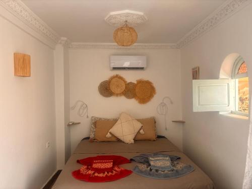 a small bedroom with a bed in a room at Riad Sanwa in Marrakech