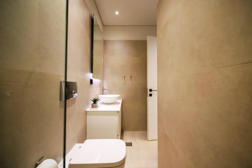 a bathroom with a toilet and a sink at Anna's Lovely Corfu Studio in Corfu