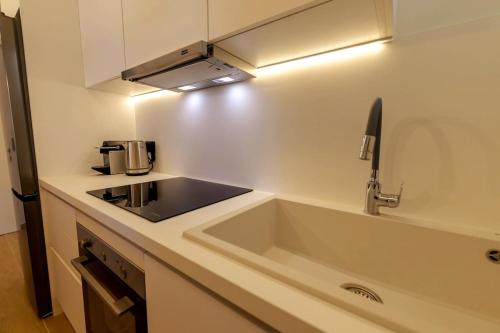 a kitchen with a sink and a stove top oven at Anna's Lovely Corfu Studio in Corfu