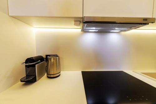 a kitchen with a coffee maker and a microwave at Anna's Lovely Corfu Studio in Corfu
