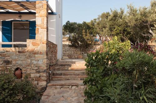 a stone stairway leading to a house with bushes at Aurea Blu studio 15 Pure nature, relaxation, sea and sun in Aliko Beach