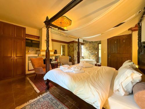 a bedroom with a bed and a living room at Pliades Traditional Guesthouse in Palaios Panteleimon