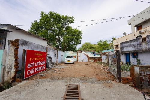 an alley with a car parked next to a building at Pvt Residency in Palni