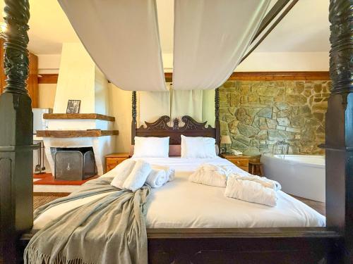 a bedroom with a bed and a bath tub and a tub at Pliades Traditional Guesthouse in Palaios Panteleimon