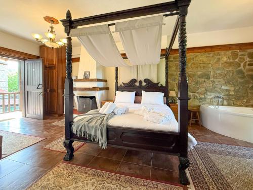 a bedroom with a bed and a bath tub at Pliades Traditional Guesthouse in Palaios Panteleimon