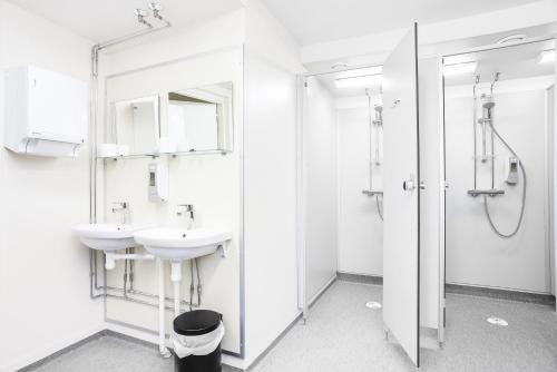 a bathroom with a toilet, sink, and shower at Forenom Hostel Vantaa Aviapolis in Vantaa