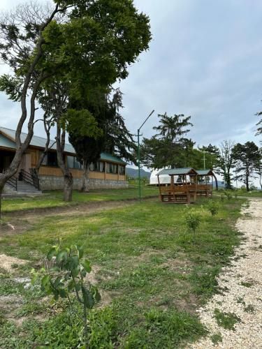 a building with a tree and a bench in a field at Loreni Garden in Getahovit