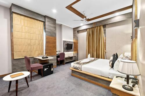a hotel room with a bed and a desk at PRIME LAND in Varanasi
