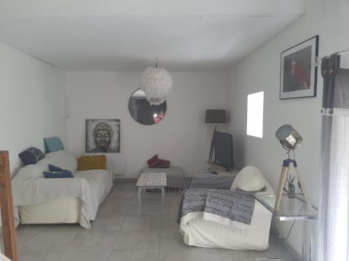 a living room with a couch and a tv at Appartement duplex 4 personnes in Loiré-sur-Nie
