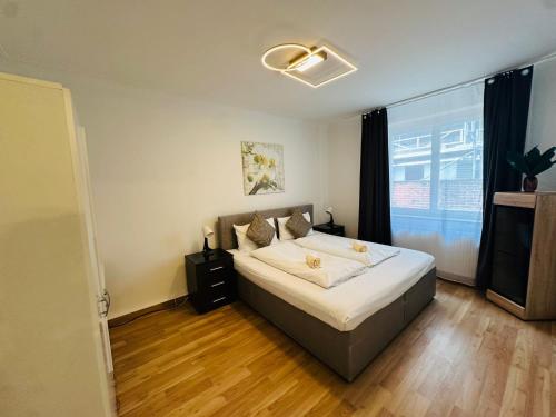 a bedroom with a bed and a large window at Cocoon City in Stuttgart