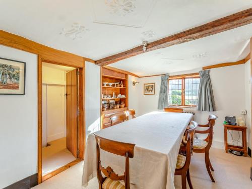 a dining room with a table and chairs at Malting Cottage in Much Hadham