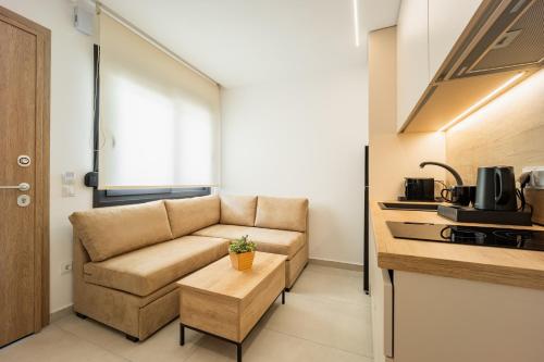 a living room with a couch and a table at Chalkidiki Suites in Paralia Dionysiou