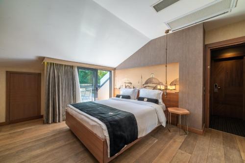 a bedroom with a large bed and a large window at Hotel Saint Sophia in Istanbul