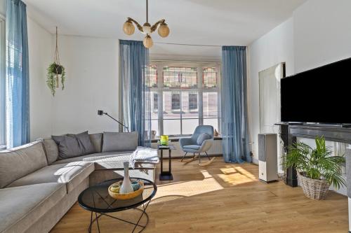 a living room with a couch and a tv at Authentic stay in Alkmaar in Alkmaar