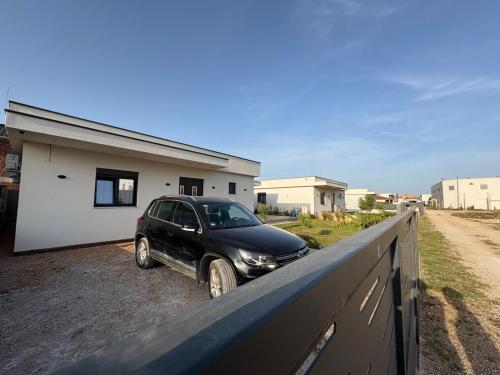 a car parked on a fence in front of a house at Luxury Villa Ulcinj Štoj in Donji Štoj
