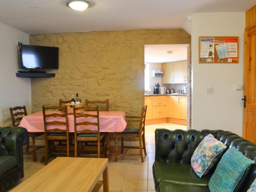 a kitchen and dining room with a table and chairs at Owl Cottage in Flamborough