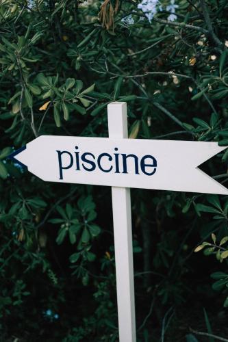 a white arrow sign with the word pleasure at Hôtel Le Provençal - Rénové en 2025 - Bord de Mer in Hyères