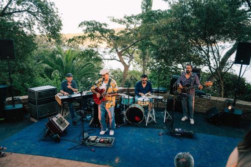 a group of people playing music on a stage at Hôtel Le Provençal - Rénové en 2025 - Bord de Mer in Hyères