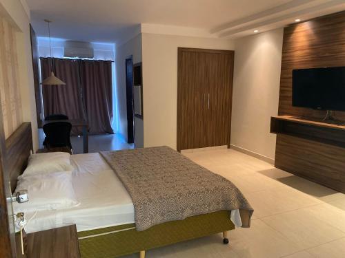 Ένα ή περισσότερα κρεβάτια σε δωμάτιο στο Hotel Vitoria Palace varginha