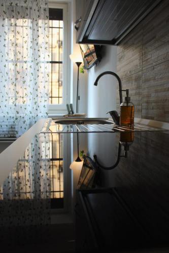 a kitchen with a sink and a window at cosycasa & free bike in Turin