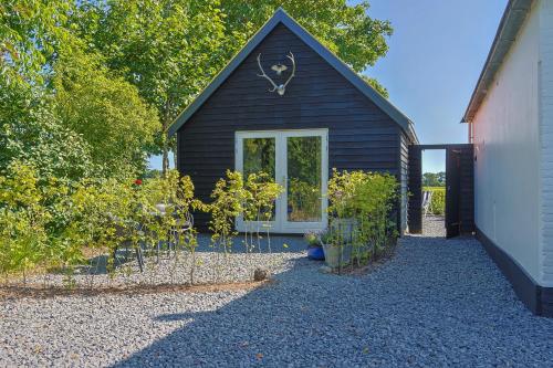 a black shed with plants in front of it at Huize Breelzicht in Mirns