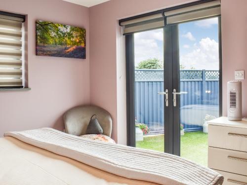 a bedroom with a sliding glass door to a balcony at Pentarow in Constantine