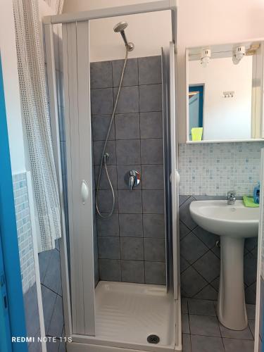 a small bathroom with a shower and a sink at appartamento celeste in Pantelleria