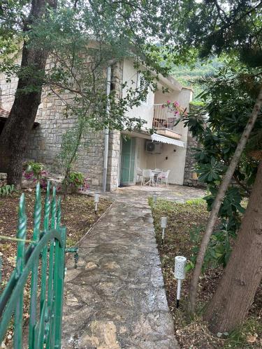 a house with a green door and a patio at Iskra house - Perazica Do in Perazića Do