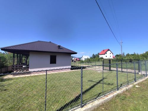 a fence in front of a house at Nikolija in Žabljak