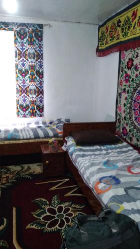 Ένα ή περισσότερα κρεβάτια σε δωμάτιο στο Begmurod guesthouse