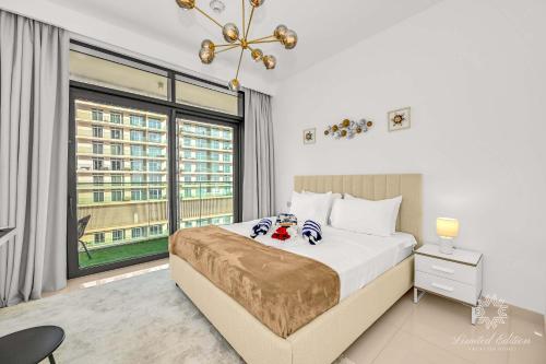 a bedroom with a bed and a large window at Luxury 2 Bedroom Apartment - Private Beach - Emaar Beach Vista in Dubai