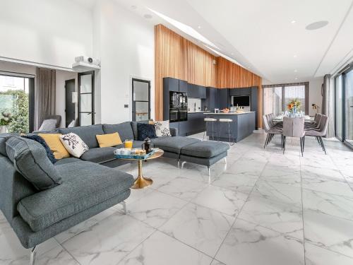a living room with a couch and a table at Seabreeze in Saint Mawes