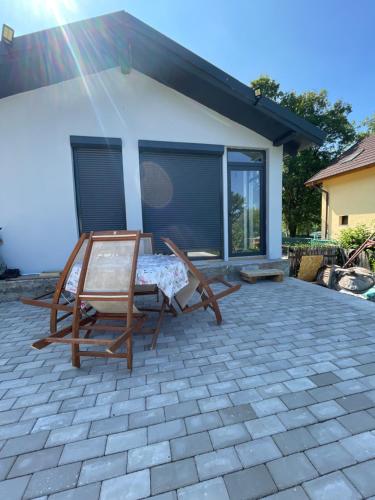 a chair on a patio in front of a house at Casa Herban 2 in Moara Ungurului