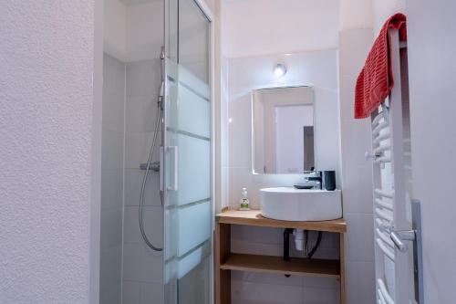 a bathroom with a sink and a shower at Capstay Lourdes - Residence Serenity in Lourdes