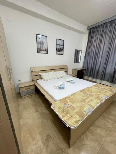 a bedroom with a large bed in a room at Kukunesh Apartments in Ohrid