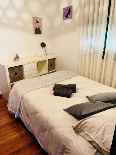 a bedroom with a bed with two pillows on it at Casa da Fonte in Combarro