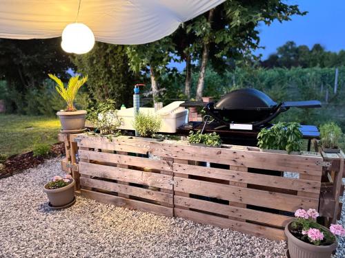 a grill with a bunch of plants in a garden at Pineta Apartment with Exclusive Pool in Campo di Pietra