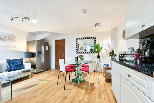 a kitchen and living room with a table and chairs at Destination London Docklands Riverside in London