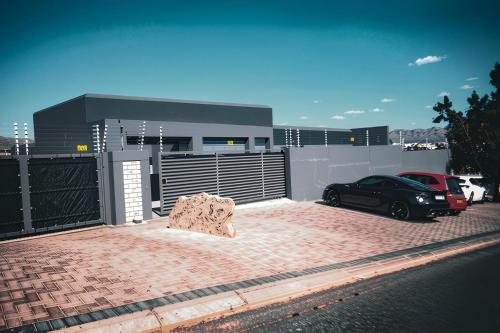 a bench sitting in front of a building at Oceana Luxury Guesthouse in Windhoek