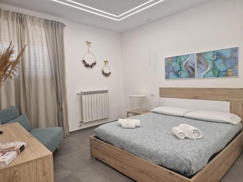 a bedroom with a bed and a blue chair at VeraLuce in Caltavuturo