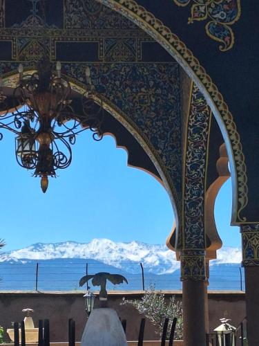 a chandelier in a building with a view of mountains at Eden Suites 