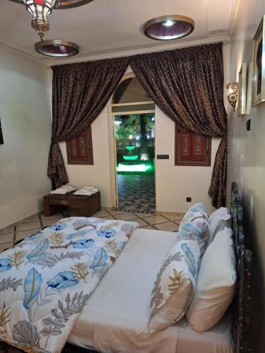 a bedroom with a large bed and a window at Eden Suites 