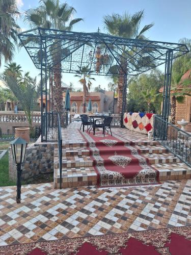 a patio with a table and benches in a courtyard at Eden Suites 