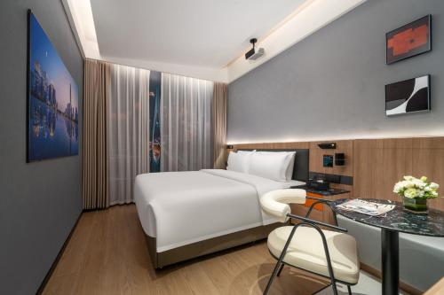 Ένα ή περισσότερα κρεβάτια σε δωμάτιο στο Jiduo Hotel Convention and Exhibition Center Branch