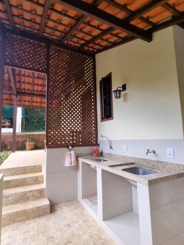 a kitchen with a sink and a counter top at Chalé Fazendinha in Bocaina de Minas
