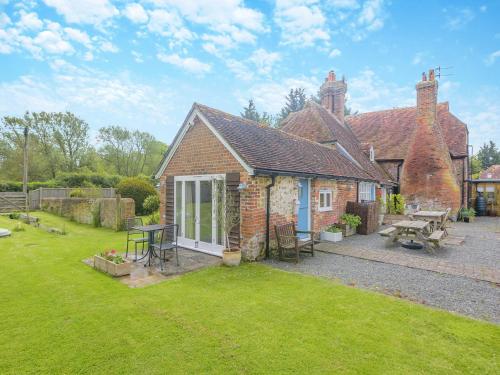 an exterior view of a brick house with a yard at Lidsey Farmhouse in Bognor Regis