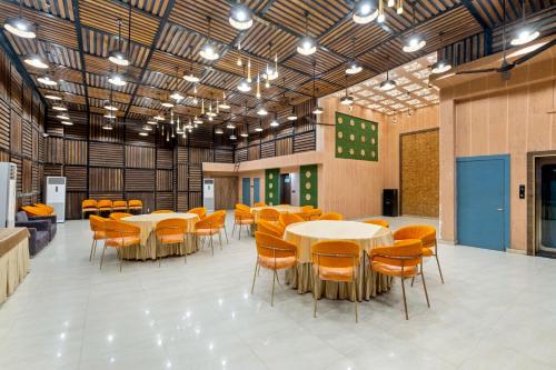 a large room with tables and chairs in it at PRIME LAND in Varanasi