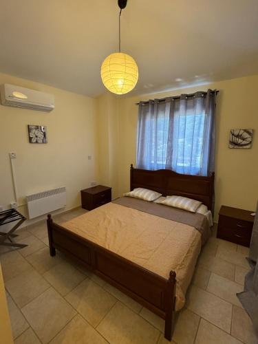 a bedroom with a large bed and a window at Stunning Traditional Stone Villa - Kallepia in Kallepia