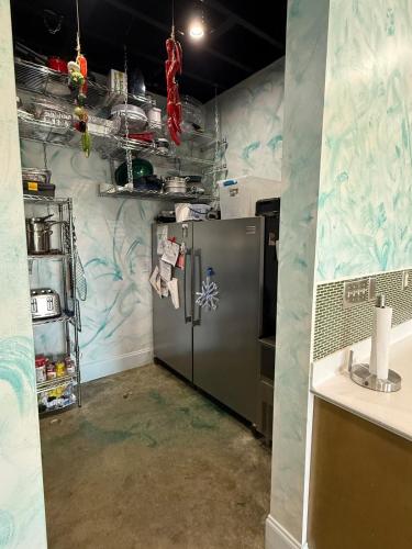 a kitchen with a stainless steel refrigerator in a room at Down on the BAY in Coden