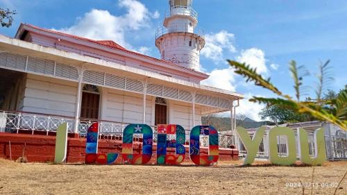 a building with a light house and a lighthouse at Sea-Sky Blue Beach Resort at Malabrigo Lobo Batangas-TW in Lobo